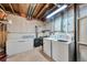 A basement utility area with exposed piping also has laundry and freezer at 293 Wagonwheel Dr, Fort Lupton, CO 80621