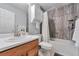Clean bathroom featuring a shower-tub combo, vanity with sink, and storage for a clutter-free space at 293 Wagonwheel Dr, Fort Lupton, CO 80621