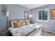 Comfortable bedroom with a large window and stylish decor for a cozy and inviting atmosphere at 293 Wagonwheel Dr, Fort Lupton, CO 80621