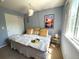Well-lit bedroom featuring a comfortable bed, window, and modern decor at 293 Wagonwheel Dr, Fort Lupton, CO 80621