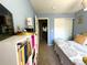 A bedroom with muted blues walls and white trim provides access to a closet and hallway at 293 Wagonwheel Dr, Fort Lupton, CO 80621