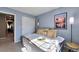 Bright bedroom featuring a picture window, and closet doors for ample storage space at 293 Wagonwheel Dr, Fort Lupton, CO 80621