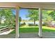 Beautiful view of the green grass and lake from the covered patio at 293 Wagonwheel Dr, Fort Lupton, CO 80621