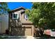 Charming two-story home with attached garage, wood siding, and neatly landscaped front yard at 293 Wagonwheel Dr, Fort Lupton, CO 80621
