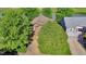 Overhead view of a brown, two-story home with mature trees and a well-maintained yard, showcasing its curb appeal at 293 Wagonwheel Dr, Fort Lupton, CO 80621