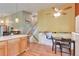 Bright kitchen with hardwood floors and a breakfast nook with bench seating by the stairs at 293 Wagonwheel Dr, Fort Lupton, CO 80621