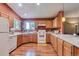 Spacious kitchen with wood cabinets, white countertops, and ample counter space for cooking and preparation at 293 Wagonwheel Dr, Fort Lupton, CO 80621