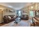 Inviting living room with comfortable leather sofas, a stylish coffee table, and decorative artwork at 293 Wagonwheel Dr, Fort Lupton, CO 80621