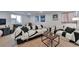 The carpeted Gathering room offers a comfortable seating area and modern decor at 293 Wagonwheel Dr, Fort Lupton, CO 80621