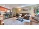 Open-concept living room seamlessly connecting to the kitchen, featuring a comfortable leather sofa and stylish decor at 293 Wagonwheel Dr, Fort Lupton, CO 80621