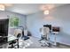 A home office is brightly lit and has a treadmill for fitness at 293 Wagonwheel Dr, Fort Lupton, CO 80621