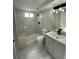Bathroom with new marble tile shower, new vanity, and modern fixtures at 8418 Ames, Arvada, CO 80003