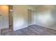 Bright bedroom featuring new flooring, neutral walls, and a spacious closet at 8418 Ames, Arvada, CO 80003
