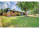 Charming single story home with brick exterior and well-maintained front yard and mature landscaping at 8418 Ames, Arvada, CO 80003