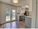 Bright kitchen with stainless steel appliances, white cabinets and double doors to the yard at 8418 Ames, Arvada, CO 80003