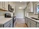 Bright kitchen featuring new stainless steel appliances, stone countertops and ample cabinet space at 8418 Ames, Arvada, CO 80003