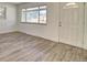 Open living room with new flooring, white walls, large front windows and contemporary design at 8418 Ames, Arvada, CO 80003