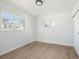 Bright bedroom features white walls, wood floors, and 2 large windows at 2295 S Sherman St, Denver, CO 80210