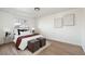 Bright bedroom features white walls, wood floors, area rug, and large window at 2295 S Sherman St, Denver, CO 80210