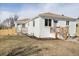 Exterior view of well-maintained white brick duplex featuring separate entrances and freshly landscaped yards at 2295 S Sherman St, Denver, CO 80210