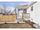 Charming white brick home featuring a welcoming front door with a small porch and recently added wooden fence at 2295 S Sherman St, Denver, CO 80210