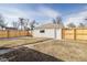 A private backyard featuring a detached garage and privacy fence at 2295 S Sherman St, Denver, CO 80210