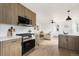 Modern kitchen with stainless steel appliances and wood cabinets, seamlessly flowing into the living space at 2295 S Sherman St, Denver, CO 80210