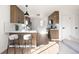 Well-lit kitchen with breakfast bar, stainless steel appliances, and modern wood cabinets at 2295 S Sherman St, Denver, CO 80210