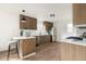 Modern kitchen with stainless steel appliances, breakfast bar, and wood cabinets, bathed in natural light at 2295 S Sherman St, Denver, CO 80210