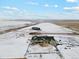 Areal view of a ranch style home on a snow covered lot with large yard and two garages and pasture views at 39200 E 148Th Ct, Keenesburg, CO 80643