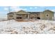 Spacious backyard with a covered patio area perfect for lounging, outdoor dining and enjoying the serene outdoors at 39200 E 148Th Ct, Keenesburg, CO 80643