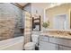 Updated bathroom featuring a tiled shower, decorative shelves, and granite countertop sink at 39200 E 148Th Ct, Keenesburg, CO 80643