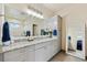 Modern bathroom vanity with double sinks, granite countertop, and a large mirror at 39200 E 148Th Ct, Keenesburg, CO 80643