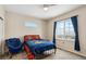 Cozy bedroom with ceiling fan, a large window, and comfortable furniture at 39200 E 148Th Ct, Keenesburg, CO 80643