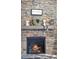 Close-up of a stone fireplace with a decorative mantel and hearth at 39200 E 148Th Ct, Keenesburg, CO 80643