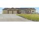 Charming single-story home featuring a three-car garage, stone accents, and a well-maintained lawn at 39200 E 148Th Ct, Keenesburg, CO 80643