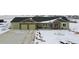 Single-story home with a three-car garage, stone accents, and landscaping in a wintery setting at 39200 E 148Th Ct, Keenesburg, CO 80643