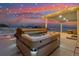 Enjoy evening relaxation in this hot tub with open views and ambient string lights under a covered patio at 39200 E 148Th Ct, Keenesburg, CO 80643
