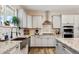 Stylish kitchen featuring gray cabinets, granite countertops, and stainless steel appliances at 39200 E 148Th Ct, Keenesburg, CO 80643