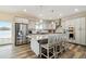 Modern kitchen with stainless steel appliances, gray cabinets, and a granite island with seating at 39200 E 148Th Ct, Keenesburg, CO 80643