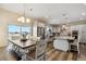 Open concept kitchen and dining area with stainless steel appliances, gray cabinets, and wood floors at 39200 E 148Th Ct, Keenesburg, CO 80643