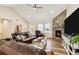 Inviting living room featuring a stone fireplace, wood flooring, and comfortable seating at 39200 E 148Th Ct, Keenesburg, CO 80643