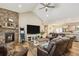 Cozy living room featuring a stone fireplace, wood flooring, and vaulted ceilings at 39200 E 148Th Ct, Keenesburg, CO 80643