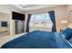 Cozy primary bedroom with a large window, blue bedding, carpet flooring, and an attached bath at 39200 E 148Th Ct, Keenesburg, CO 80643