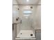 Walk-in shower with glass door, rain shower head, built in bench, and designer tile at 39200 E 148Th Ct, Keenesburg, CO 80643