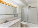 Clean bathroom with a shower-tub combo, toilet, sink and mirror providing functionality at 620 S Alton Way # 5B, Denver, CO 80247