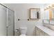 Cozy bathroom featuring a shower, toilet, sink, and mirror providing functionality at 620 S Alton Way # 5B, Denver, CO 80247