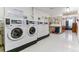 On-site laundry room with multiple washers and dryers for tenant use at 620 S Alton Way # 5B, Denver, CO 80247