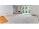 Spacious living room with neutral carpet, baseboard heating, and access to the balcony for effortless relaxation and enjoyment at 620 S Alton Way # 5B, Denver, CO 80247