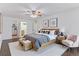 Stylishly staged bedroom with wooden accents, overhead fan, and light pink accent chair at 620 S Alton Way # 5B, Denver, CO 80247